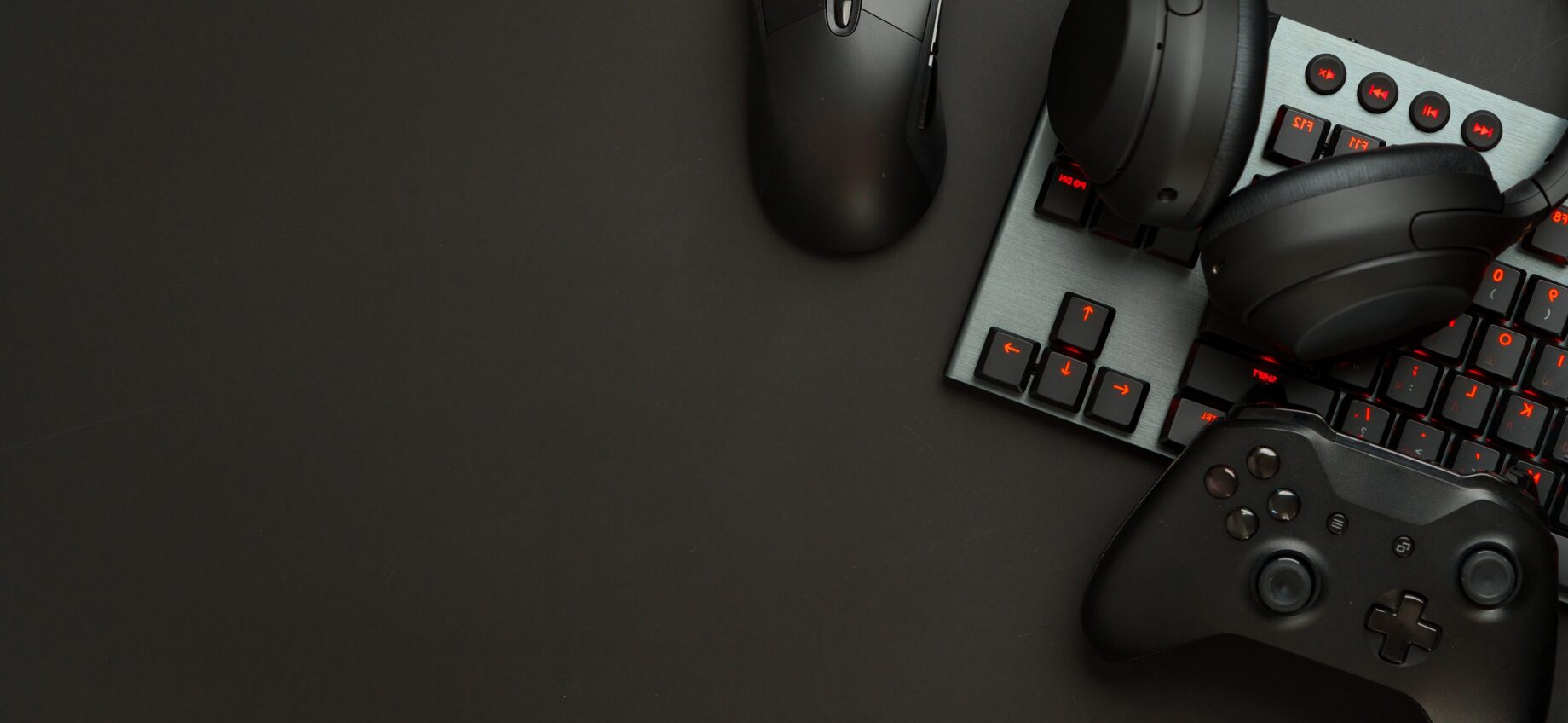Gaming gear: mouse, keyboard, controller, headphones.