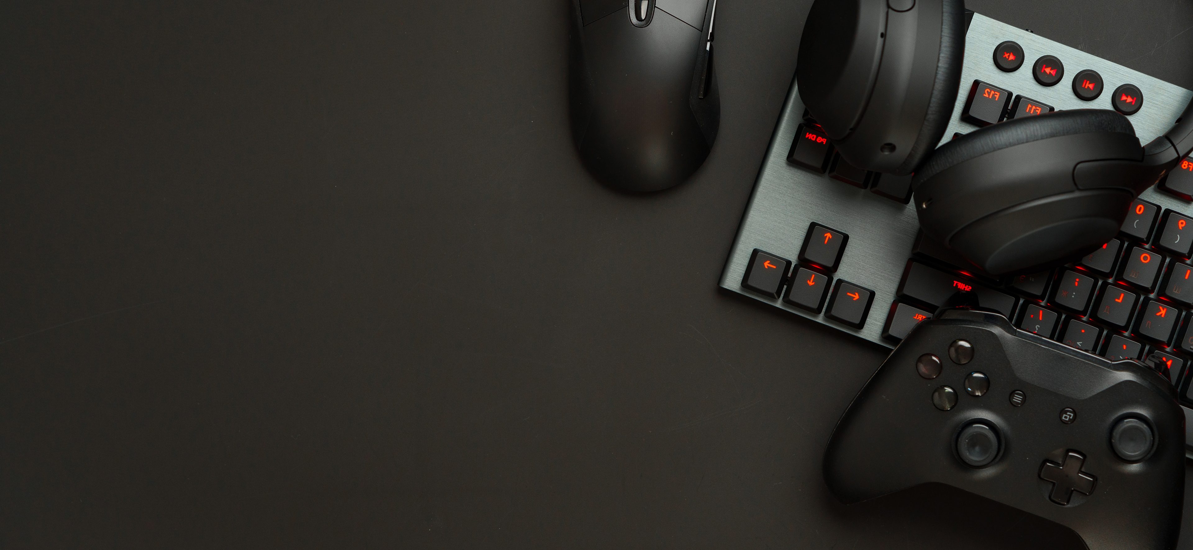 Gaming gear: mouse, keyboard, controller, headphones.